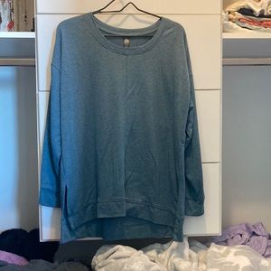 Blue long sleeve that has sides cut out about 3 inches up